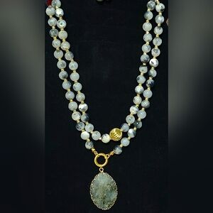 Beaded gemstone necklace featuring an oval pendant